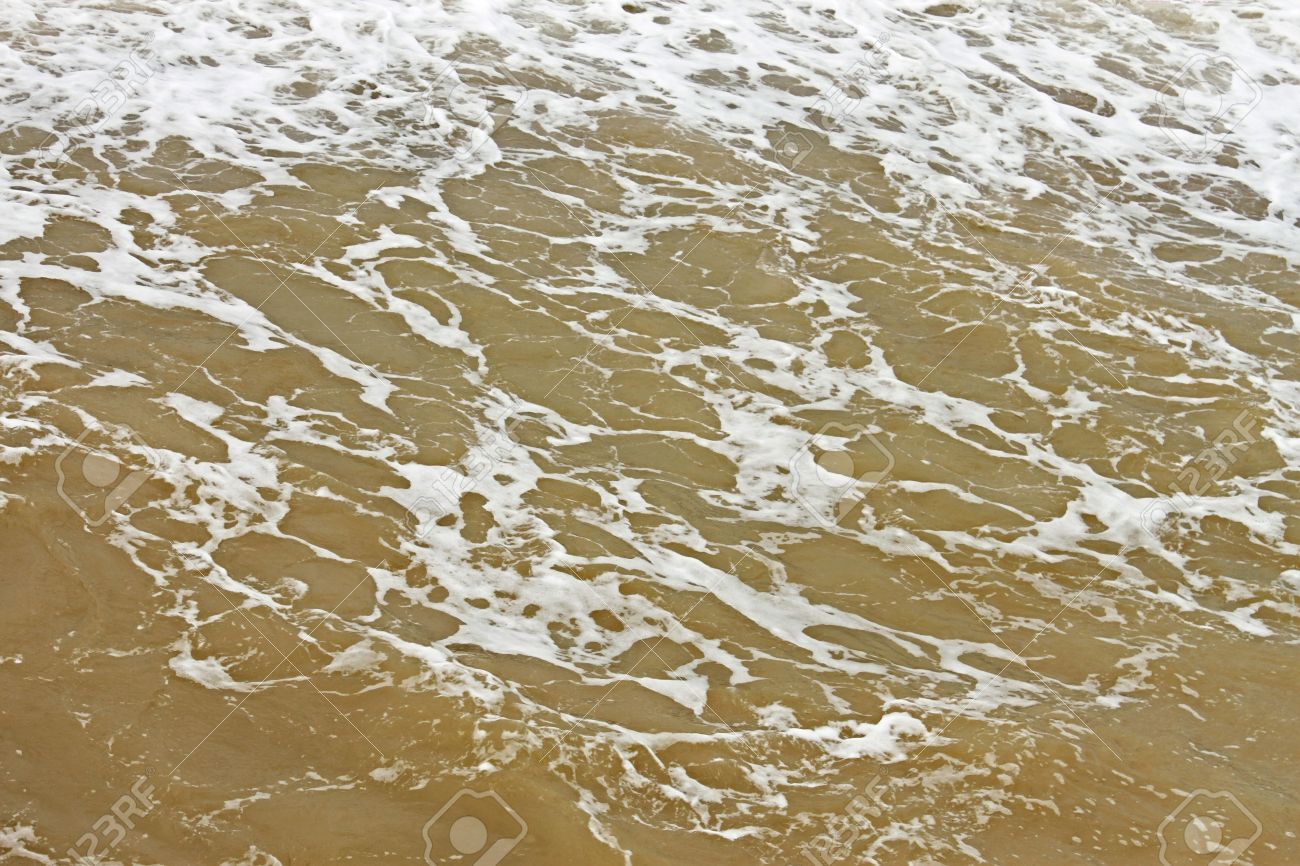 21132434-coastal-foamy-seawater-surface-after-the-storm-polluted-dredged-from-the-seabed-sand-stock-photo
