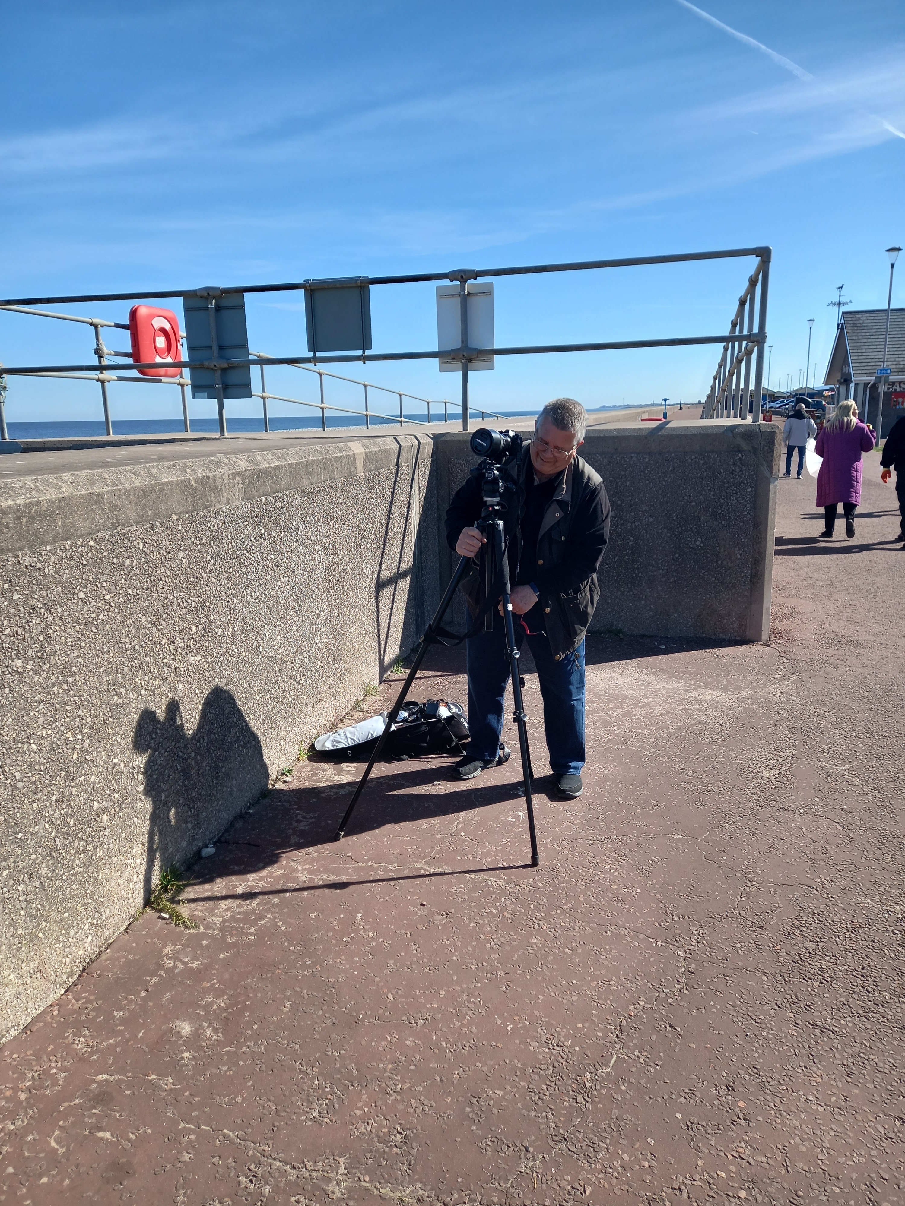 Film maker George Frost setting up on Pensarn prom to film Diane Woodrow for a promotional video for her book The Little Yellow Boat